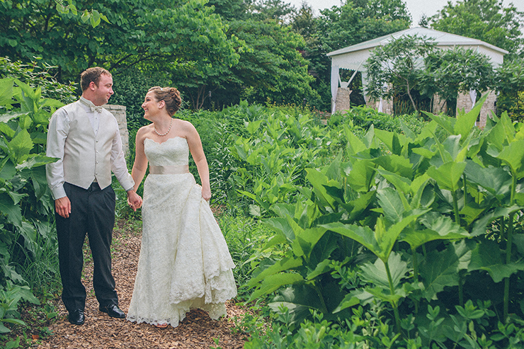 Married couple walking through garden