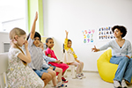 students and teacher sitting in a circle