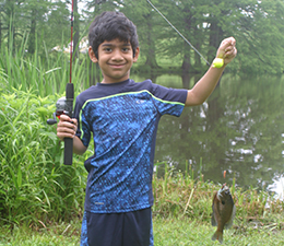 Child with just-caught fish