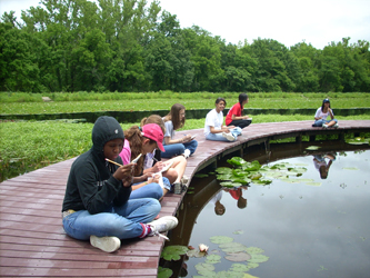 Students sketching on boardwalk